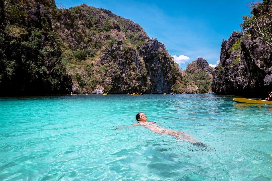 Girl swimming at Big Lagoon El Nido