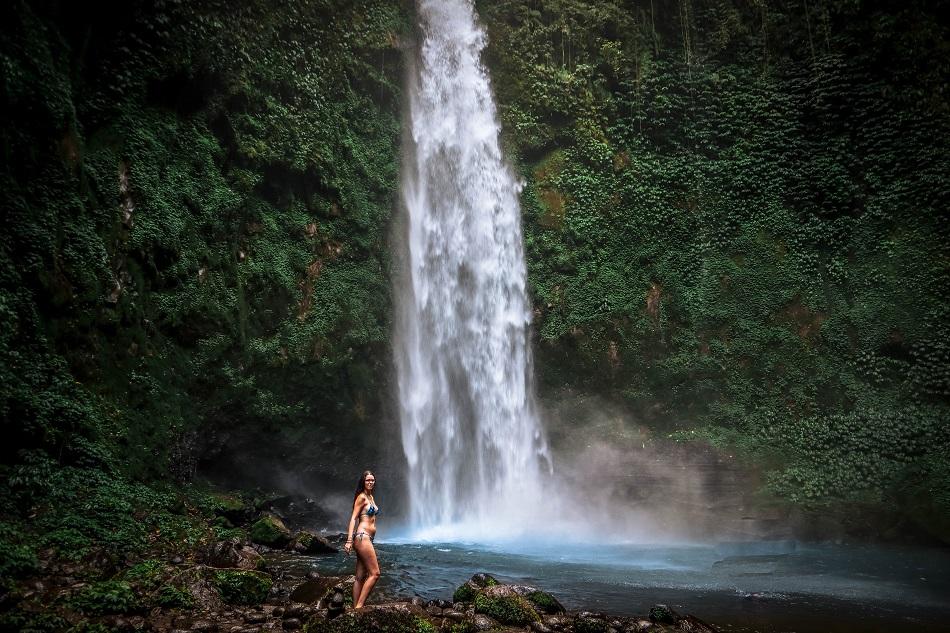 Girl in swimming suit at Nungnung Waterfall, Bali