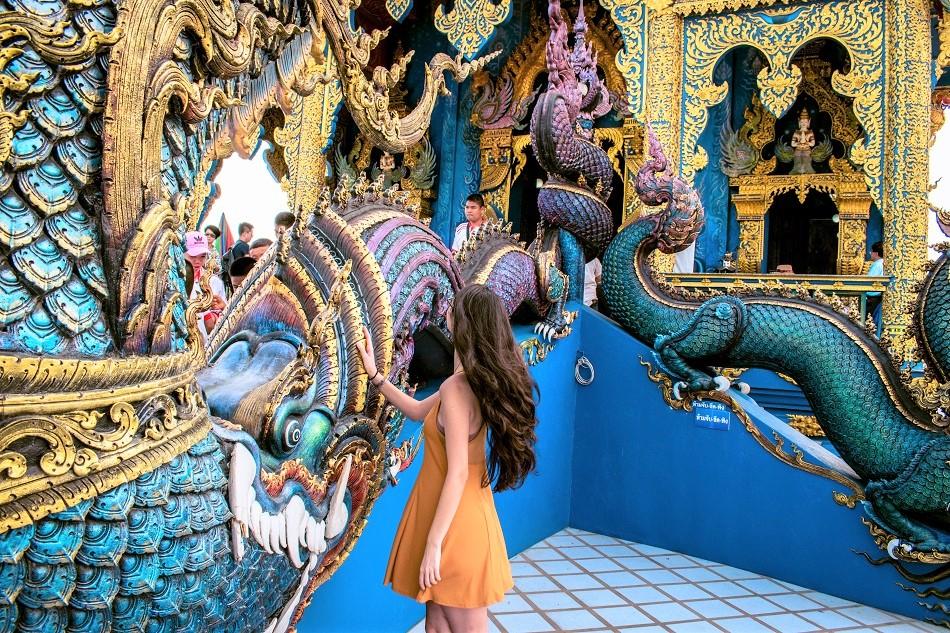 Girl at Blue Temple Chiang Rai, also known as Wat Rong Seua Ten