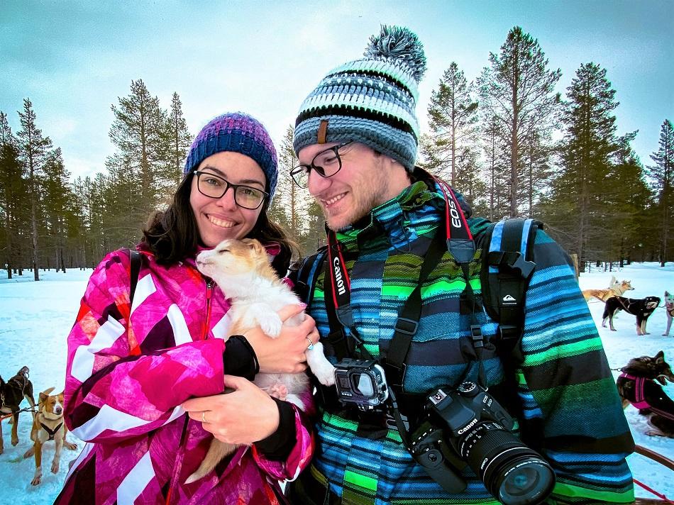 girl holding a husky puppy in Lapland, Finland