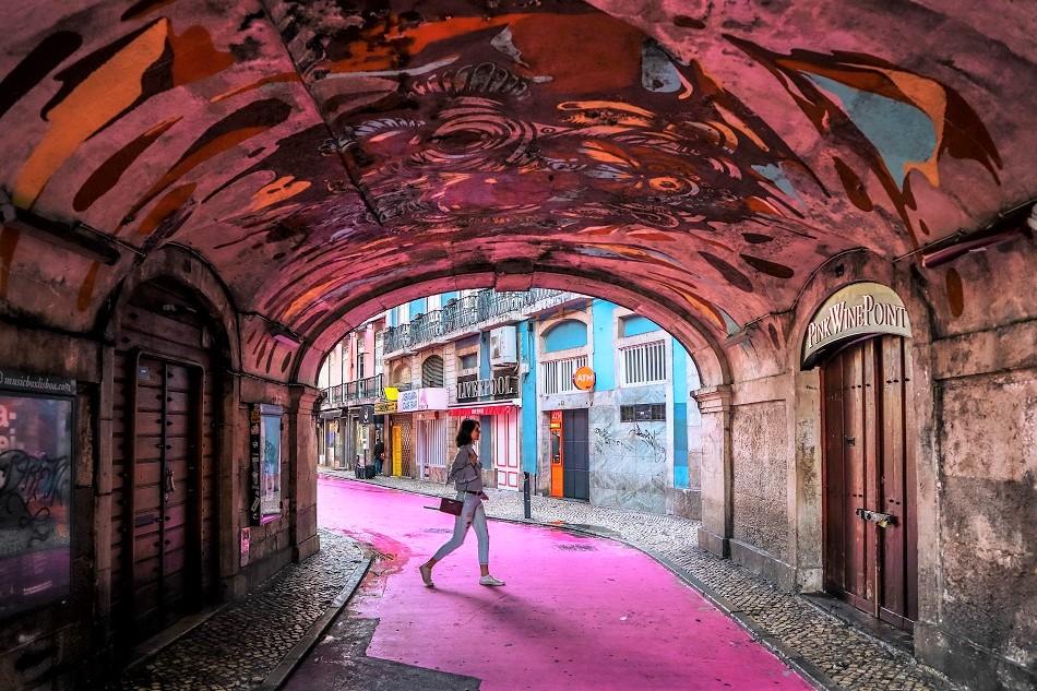 Girl walking on the Pink Street in Lisbon