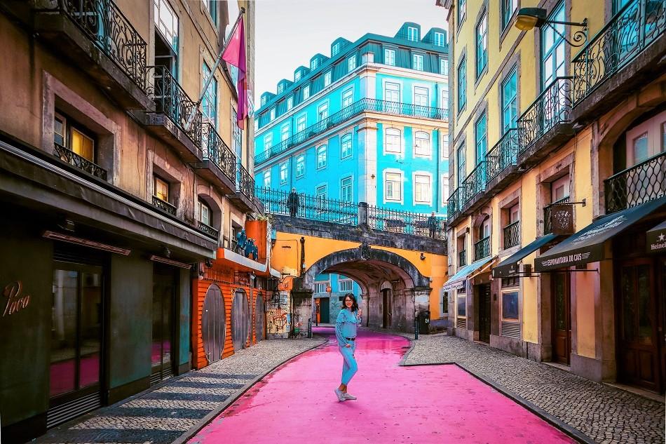 Girl in the middle of Pink Street, Lisbon, also known as Rua Nova do Carvalho